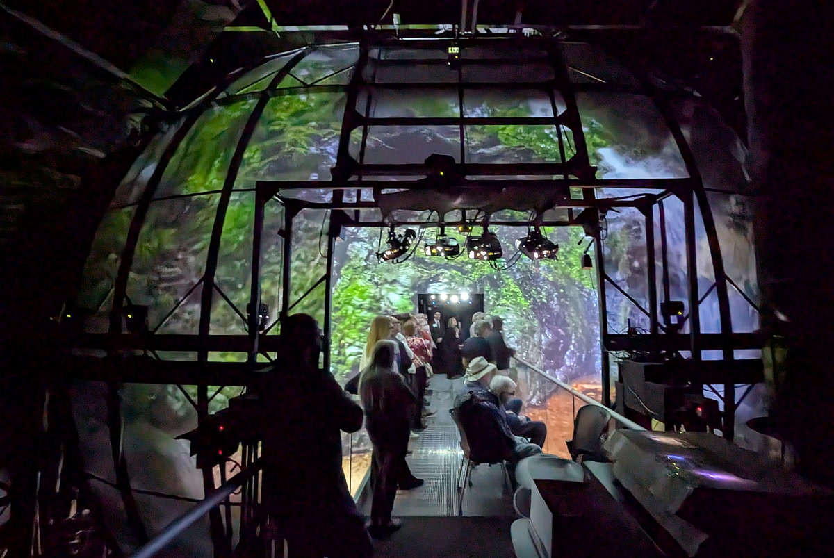 Visitors on the bridge inside the AlloSphere during an immersive projection